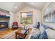 Cozy living room features a fireplace, large window and comfortable seating at 41 Barton Ridge Dr, Breckenridge, CO 80424