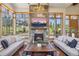 Inviting living room featuring a stone fireplace and large windows with scenic views of mountains at 41 Barton Ridge Dr, Breckenridge, CO 80424