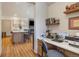 Cozy home office with built-in desk and shelving, open to kitchen, and fireplace at 41 Barton Ridge Dr, Breckenridge, CO 80424
