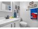 Clean bathroom with white vanity, a black faucet, and superhero decor at 12233 W Cross Dr # 204, Littleton, CO 80127