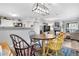 Open concept dining area with a view into the living room and kitchen at 12233 W Cross Dr # 204, Littleton, CO 80127