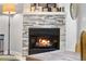 Modern stone fireplace with a sleek design and glowing fire at 12233 W Cross Dr # 204, Littleton, CO 80127