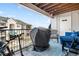 Private covered patio with seating and grill at 12233 W Cross Dr # 204, Littleton, CO 80127