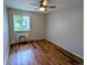 Bright bedroom with hardwood floors, a ceiling fan, and a large window at 17361 E Mansfield Ave # 532R, Aurora, CO 80013