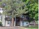 Exterior of an apartment complex with balconies, lush trees, and ample parking space at 17361 E Mansfield Ave # 532R, Aurora, CO 80013