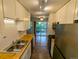Galley kitchen with butcher block counters, stainless steel appliances, and balcony access at 17361 E Mansfield Ave # 532R, Aurora, CO 80013