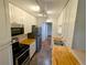 Galley kitchen boasting stainless appliances, light wood counters, and modern lighting at 17361 E Mansfield Ave # 532R, Aurora, CO 80013