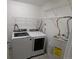 Bright laundry room complete with a washer, dryer, and water heater at 17361 E Mansfield Ave # 532R, Aurora, CO 80013