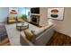 Cozy living room with a stone fireplace, neutral walls, a patterned rug, and modern furniture at 17361 E Mansfield Ave # 532R, Aurora, CO 80013