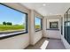 Bright balcony features large windows with black frames overlooking a scenic green field on a sunny day at 11481 E Briarwood Cir, Centennial, CO 80112