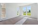 Bright bedroom with carpet flooring and large windows offering a view of green fields at 11481 E Briarwood Cir, Centennial, CO 80112