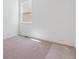 Bedroom features neutral carpet, white walls, and a window offering natural light at 11481 E Briarwood Cir, Centennial, CO 80112