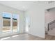 The entryway showcases two large windows, an exterior door, and a modern black railing staircase at 11481 E Briarwood Cir, Centennial, CO 80112