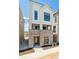 Contemporary townhome with brick base, large windows, and well-manicured landscaping at 11481 E Briarwood Cir, Centennial, CO 80112