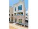 Modern townhome showcasing brick facade, sizable windows, and inviting entrance at 11481 E Briarwood Cir, Centennial, CO 80112