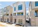 Modern townhome features brick facade, large windows, and a small balcony at 11481 E Briarwood Cir, Centennial, CO 80112