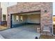 Spacious garage with exposed brick exterior and large garage door, offering ample parking and storage at 11481 E Briarwood Cir, Centennial, CO 80112