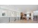 Modern, open-plan living room and kitchen featuring sleek railing and lots of natural light at 11481 E Briarwood Cir, Centennial, CO 80112