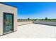Spacious outdoor patio with white tile flooring and views of trees at 11481 E Briarwood Cir, Centennial, CO 80112