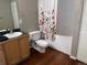 Bathroom features a shower/tub combo, wood floors and single sink vanity at 1555 California St # 302, Denver, CO 80202