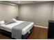 Bedroom with hardwood floors and a gray accent wall at 1555 California St # 302, Denver, CO 80202