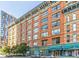 Street view of a brick loft building with large windows and commercial spaces on the ground floor at 1555 California St # 302, Denver, CO 80202