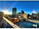 Sun-drenched city view featuring downtown skyscrapers with a rooftop foreground at 1555 California St # 302, Denver, CO 80202