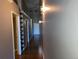 Long hallway with wood flooring and decorative wall sconces at 1555 California St # 302, Denver, CO 80202