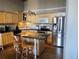 Well-lit kitchen features light wood cabinetry, granite countertops, and stainless steel appliances at 1555 California St # 302, Denver, CO 80202