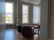Bright living room with large windows and cozy leather seating area with wood floors at 1555 California St # 302, Denver, CO 80202