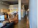 Open-concept living space with a kitchen, hardwood floors, and comfortable leather furniture at 1555 California St # 302, Denver, CO 80202