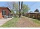 An extended patio and spacious yard, enclosed by a sturdy wooden fence offering privacy and space at 8100 W 8Th Ave, Lakewood, CO 80214