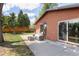 The patio area features outdoor seating and offers a view of the expansive, fenced backyard at 8100 W 8Th Ave, Lakewood, CO 80214