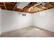 Unfinished basement with two windows and an exposed rafter ceiling at 8100 W 8Th Ave, Lakewood, CO 80214