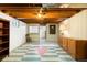 Finished basement features vintage flooring and layout with an exposed ceiling at 8100 W 8Th Ave, Lakewood, CO 80214