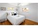 Bright bedroom features hardwood floors, updated lighting and neutral decor at 8100 W 8Th Ave, Lakewood, CO 80214
