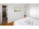 Cozy bedroom features hardwood floors and attached bathroom at 8100 W 8Th Ave, Lakewood, CO 80214