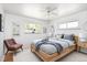 Bright bedroom features hardwood floors, updated lighting and neutral decor at 8100 W 8Th Ave, Lakewood, CO 80214