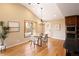 Bright dining room featuring hardwood floors, large windows, and modern lighting at 8100 W 8Th Ave, Lakewood, CO 80214