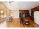 Open concept kitchen and dining area with hardwood floors, island with breakfast bar, and stainless steel appliances at 8100 W 8Th Ave, Lakewood, CO 80214