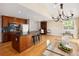 Open kitchen with an island, hardwood floors, and stainless steel appliances at 8100 W 8Th Ave, Lakewood, CO 80214