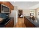Bright kitchen boasts wood floors, a dark countertop island, stainless steel appliances, and wood cabinetry at 8100 W 8Th Ave, Lakewood, CO 80214