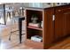 Close-up of kitchen island with breakfast bar seating and wooden shelving at 8100 W 8Th Ave, Lakewood, CO 80214