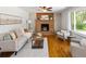 Inviting living room with a brick fireplace, wood floors, and comfortable seating at 8100 W 8Th Ave, Lakewood, CO 80214