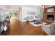 Open living room with fireplace, console table, hardwood floors, and plenty of natural light at 8100 W 8Th Ave, Lakewood, CO 80214