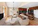Open concept living room and kitchen with hardwood floors, an island with breakfast bar, and vaulted ceilings at 8100 W 8Th Ave, Lakewood, CO 80214