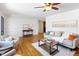 Open living room with hardwood floors, neutral paint, contemporary decor, and a ceiling fan at 8100 W 8Th Ave, Lakewood, CO 80214
