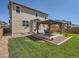 Landscaped backyard with grass and a covered patio at 12734 E 104Th Pl, Commerce City, CO 80022
