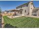 Landscaped backyard with grass and a covered patio at 12734 E 104Th Pl, Commerce City, CO 80022