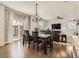 Bright dining area features sliding glass doors, hardwood flooring, and backyard access at 12734 E 104Th Pl, Commerce City, CO 80022